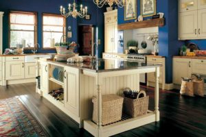 classic blue kitchen with cream cabinets and chandelier