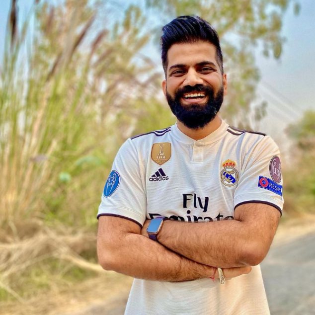 Richest youtuber gaurav chaudhary wearing white t-shirt standing on road